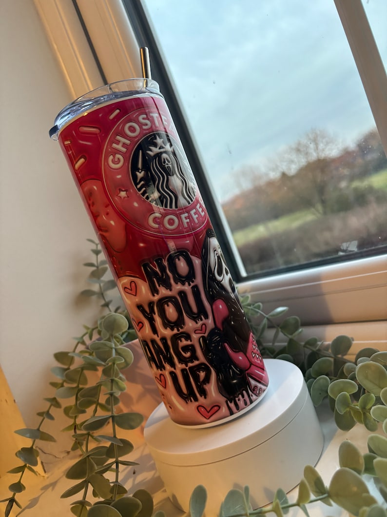 May include: Pink and black stainless steel tumbler with a ghost coffee logo and the text "No you hang up".