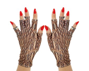 May include: A pair of fingerless gloves with a brown, textured pattern resembling reptile skin. The gloves are worn on hands with red nail polish, creating a striking contrast. The gloves are designed to cover the palm and fingers.