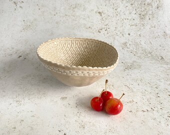 Ceramic pinch bowl with hand applied slip decoration