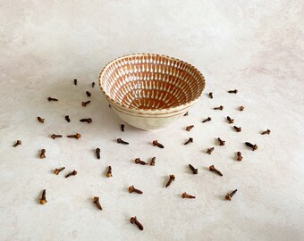 Rust red ceramic pinch bowl with hand applied porcelain slip decoration