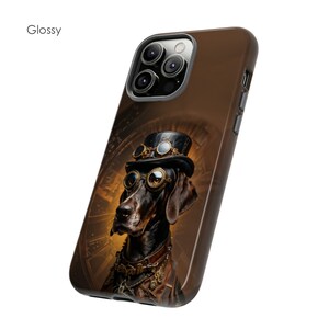 May include: A brown and black phone case featuring a steampunk dog wearing goggles and a top hat. The case has a brown background with a gold clock face design.