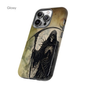 May include: A black and white illustration of the Grim Reaper with a scythe on a brown and beige background. The image is printed on a glossy phone case.