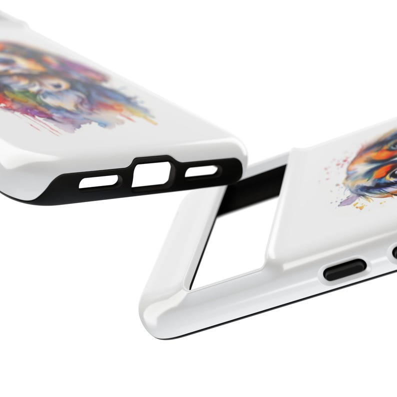May include: A white phone case featuring a watercolour design of a dog's face. The case has a black bumper and a cut-out for the camera lens.