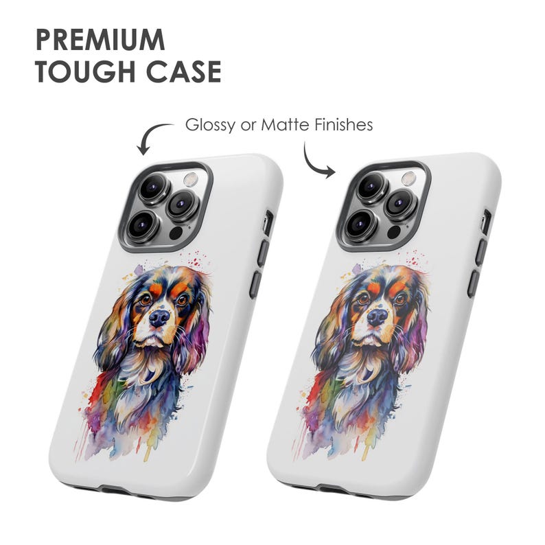 May include: Two white phone cases featuring a watercolour illustration of a Cavalier King Charles Spaniel dog. The cases have a glossy or matte finish and include a cutout for the phone's camera.