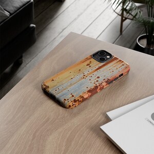 May include: A phone case with a rusty metal design. The case is made of a hard plastic material and has a raised lip around the camera lens to protect it from scratches.
