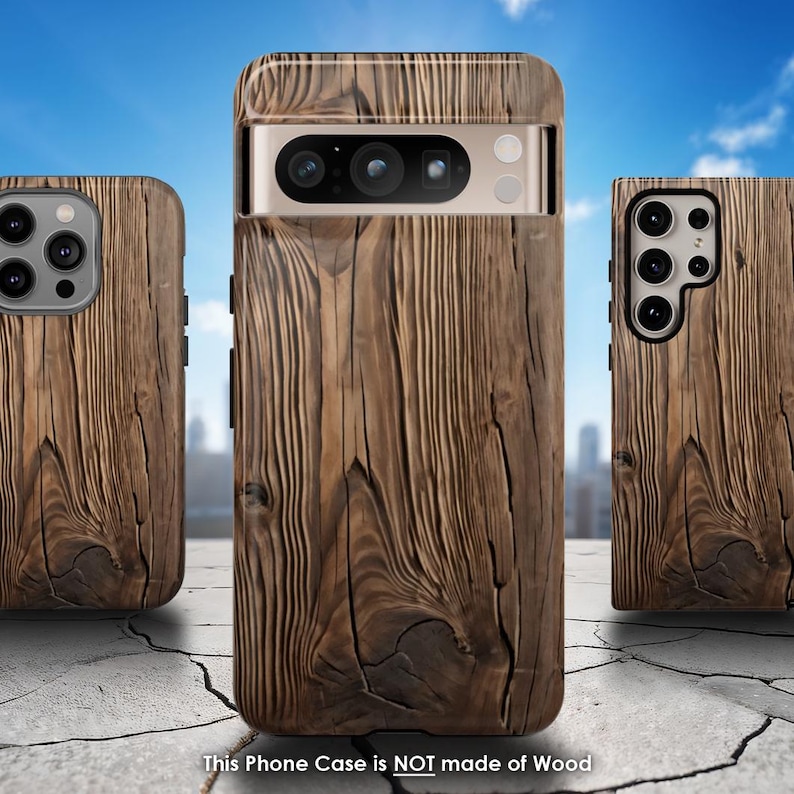 Op de afbeelding: Drie telefoonhoesjes met een houtnerfdesign. De telefoonhoesjes zijn bruin en hebben een textuur. De tekst "This Phone Case is NOT made of Wood" staat onderaan de afbeelding.