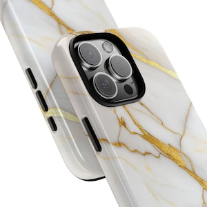 May include: White and gold marble phone case with a black camera bump and three lenses.