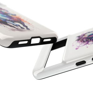 May include: Two white phone cases with a black trim. One case features a watercolour design of a horse with purple, blue, and pink colours. The other case has a similar design but is not visible in the image.