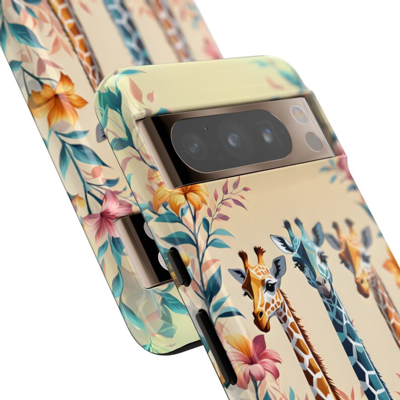 May include: A beige phone case with a floral pattern and three giraffes. The case has a camera lens cutout with three black lenses.