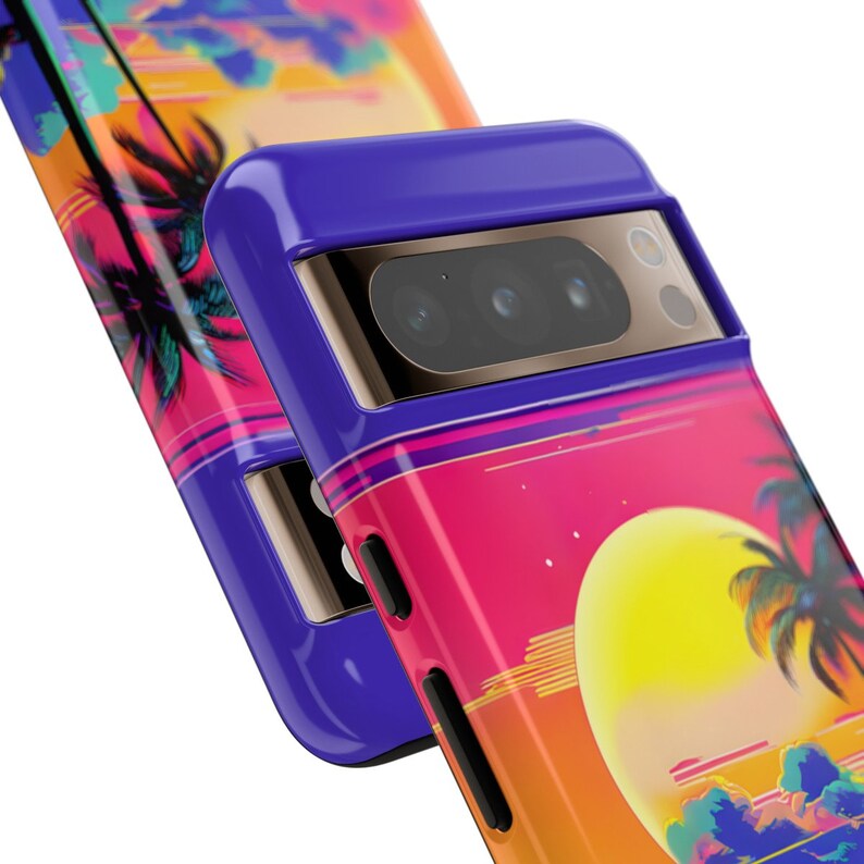 May include: A purple phone case featuring a sunset and palm tree design. The case has a gold camera ring with three lenses.