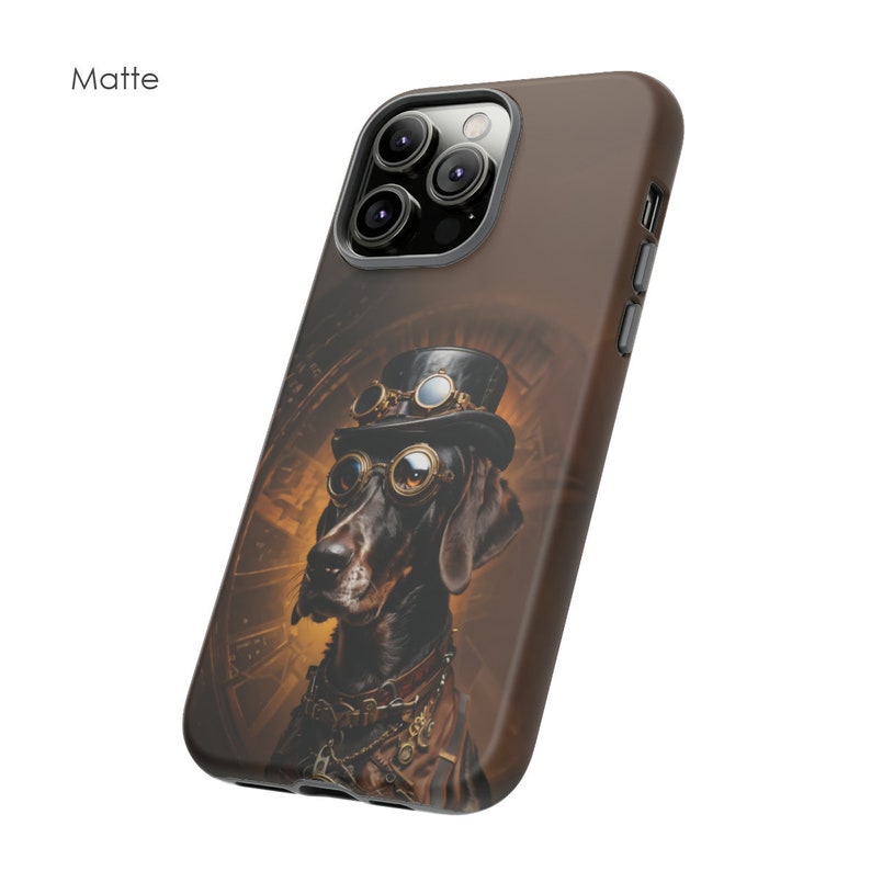 May include: A brown and black phone case featuring a steampunk-style illustration of a dog wearing goggles and a top hat. The case has a matte finish and a camera cutout.