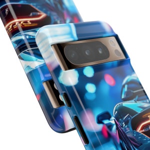 May include: A blue and black phone case featuring a blurred image of a car driving through a city at night. The case has a raised camera bump with three lenses.