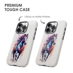 May include: Two white phone cases featuring a colourful watercolour painting of a horse running. The cases have a glossy or matte finish and feature a camera cutout.