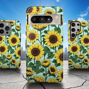 May include: Three phone cases with a sunflower pattern on a light blue background. The cases are all different sizes and have a cutout for the camera lens.