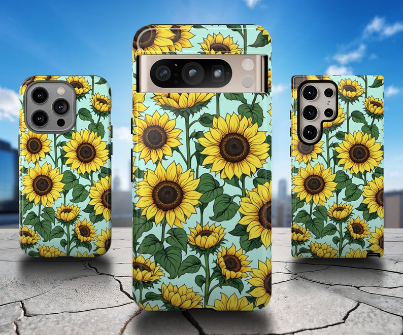 May include: Three phone cases with a sunflower pattern on a light blue background. The cases are all different sizes and have a cutout for the camera lens.