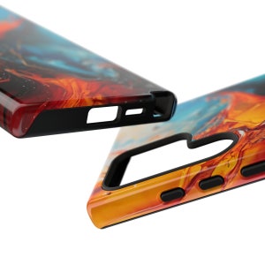 Puede incluir: Una funda para tel&eacute;fono con un dise&ntilde;o abstracto colorido en tonos naranja, amarillo, azul y negro. La funda tiene un parachoques negro y una lente de c&aacute;mara elevada.