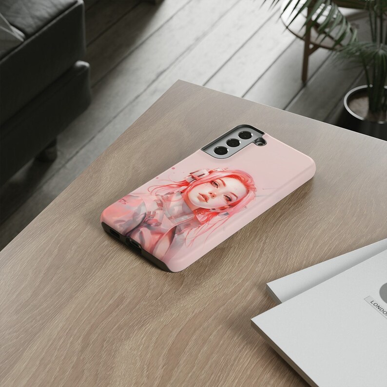 May include: A pink phone case with a design of a woman with pink hair. The case has a cutout for the camera lens.