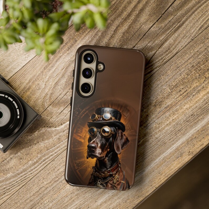 May include: A brown phone case featuring a steampunk-style illustration of a dog wearing goggles and a top hat.