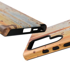 May include: A phone case with a rusty metal design. The case is made of a hard plastic material and has a black rubber bumper. The case is shown from two different angles.