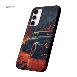 May include: A black phone case with a matte finish featuring a vintage hot rod car illustration against a city skyline backdrop.