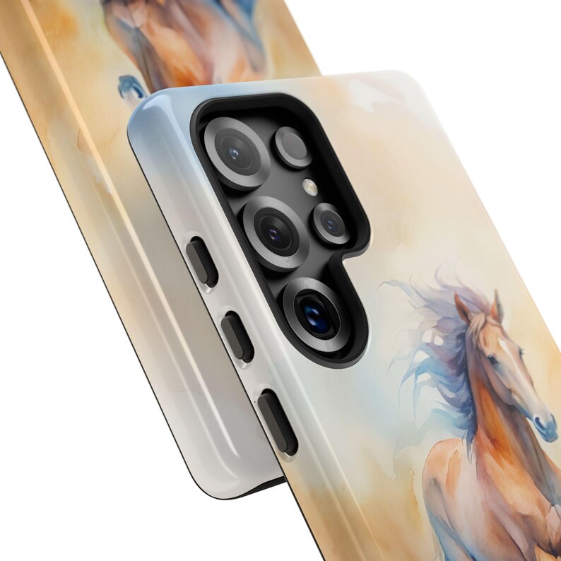 May include: A white phone case featuring a watercolour painting of a brown horse running. The case has a camera bump with four lenses.