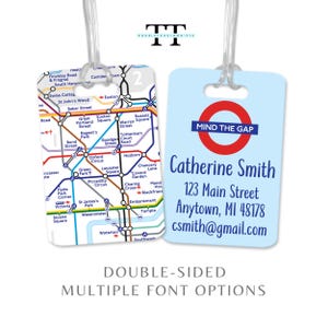 May include: Two double-sided luggage tags. One tag features a London Underground map, the other a light blue background with the text "MIND THE GAP" and contact information. The tags are clear with a plastic loop.