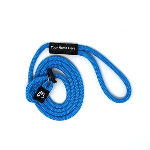May include: A blue rope lanyard with a black tag that says "Your Name Here".