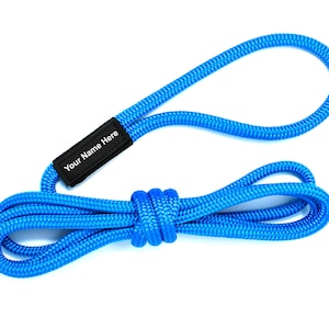 May include: A bright blue rope dog leash with a black adjustable collar that says "Your Name Here" in white text.
