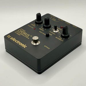 May include: A black tc electronic Stereo Chorus+ Pitch Modulator & Flanger pedal with multiple knobs and inputs. The pedal has text that reads "OUTPUT", "POWER", "INPUT", "BYPASS", and "INTENSITY". The pedal is designed for audio effects.