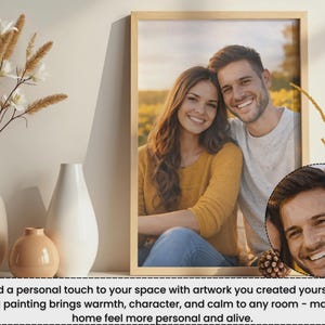 May include: A framed print featuring a smiling couple, with a smaller circular portrait of the man. The frame is light-colored, and the image is displayed with decorative vases and dried flowers.
