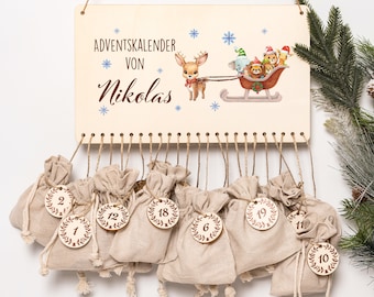 May include: Wooden Advent calendar with a reindeer pulling a sleigh with animal characters. The sign reads "Adventskalender von Nikolas" with snowflakes. Below, small beige fabric bags are numbered 1-24, each with a wooden tag.