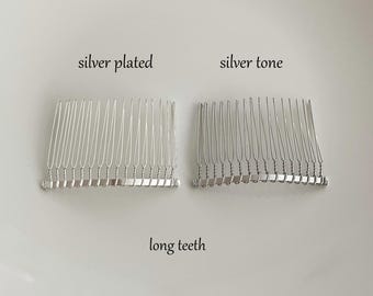 May include: Two silver hair combs with long teeth. The comb on the left is labeled "silver plated" and the comb on the right is labeled "silver tone".