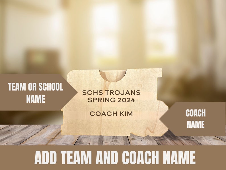 May include: A light-colored wooden plaque with the text "SCHS Trojans Spring 2024 Coach Kim" engraved on it. The plaque has a unique shape and is designed to be personalized with a team or school name and coach's name.