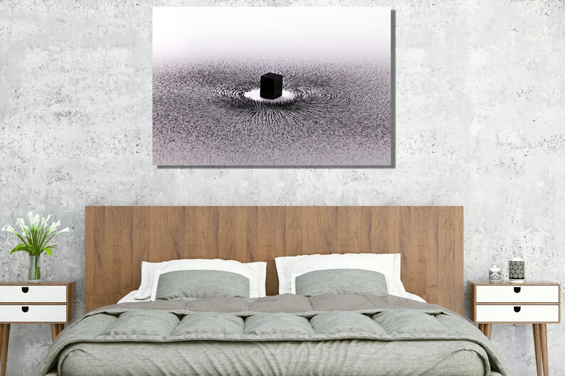 May include: A black and white abstract art print of a cube surrounded by a swirling pattern of lines. The print is framed and hanging on a wall above a bed.