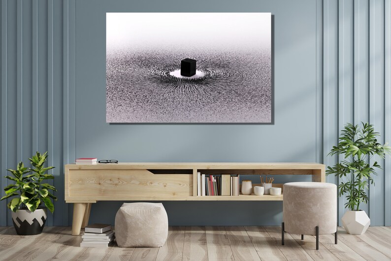 May include: A black and white abstract art print depicting a cube in the center of a swirling pattern of lines. The print is framed and hanging on a light blue wall above a wooden shelf.