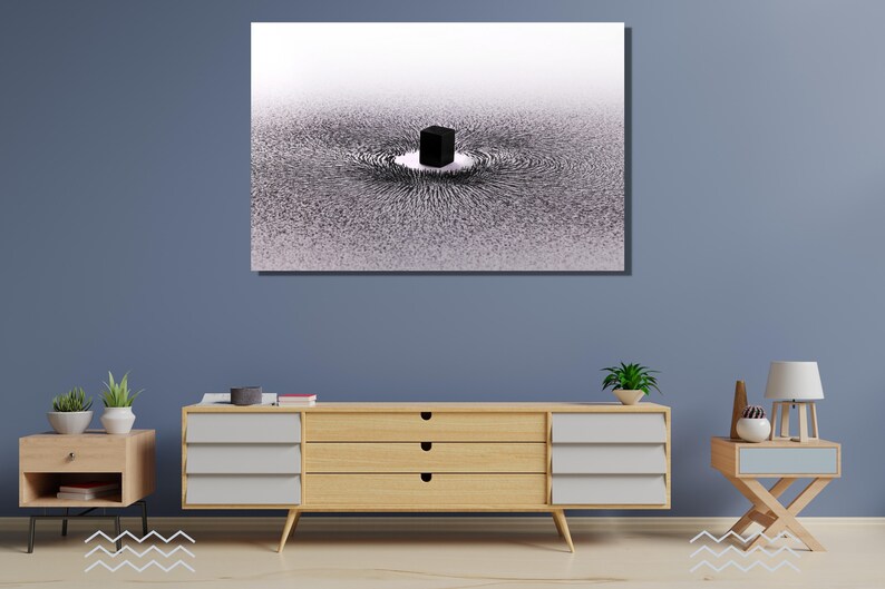 May include: A black and white abstract art print featuring a black cube in the center of a swirling pattern. The print is framed and hanging on a blue wall.
