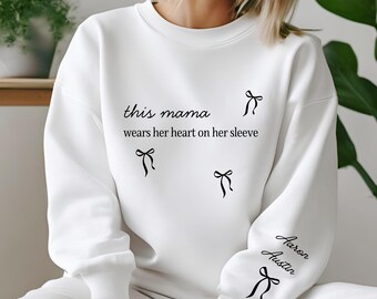 Custom This Mama Wears Her Heart On Her Sleeve Hoodie, Personalized Mom Sweatshirt With Kids Names, Cute Momma Outfit, Mothers Day Gifts