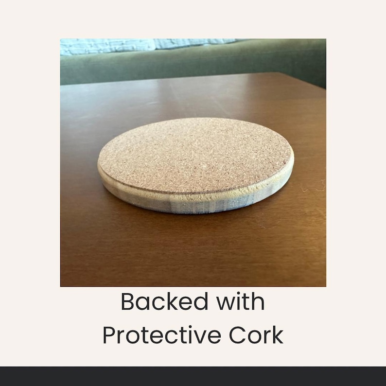 May include: A round coaster with a cork backing and a light-colored wooden edge. The coaster is on a brown wooden surface. The text "Backed with Protective Cork" is below the coaster.