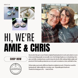 May include: The image showcases a jewelry collection with mountain landscape designs. The jewelry includes earrings, a necklace, and cufflinks. The text reads "Hi, We're Amie & Chris" and "Shop Now". The image also features a couple smiling.