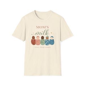 May include: Cream-colored t-shirt with the text "MOM'S milk" in a script font, and the phrase "every drop counts" below. The shirt features illustrations of five babies in various skin tones.