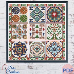May include: A framed cross-stitch pattern with nine geometric designs in a grid. The designs use blue, green, orange, and red. The frame is black, and the background is a white brick wall. The text "Pura Creations" is in the lower left corner.