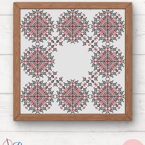 May include: A framed cross-stitch design featuring a repeating pattern of black and red geometric shapes in a circular design.
