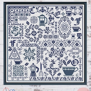 May include: A dark blue and white cross stitch pattern featuring coffee-themed motifs including a French press, a moka pot, various coffee cups, coffee beans, floral elements, decorative borders, and stylized letters arranged in a grid layout.