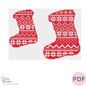 May include: A cross-stitch pattern featuring two red and white Christmas stockings with geometric snowflake and chevron motifs. The design is displayed on a grid background, with the text Pura Creations Let us cross stitching visible.