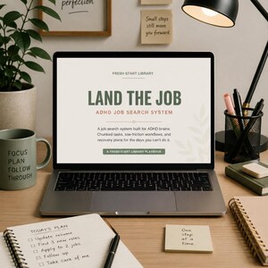 May include: A laptop displaying "LAND THE JOB" with "ADHD JOB SEARCH SYSTEM" text, alongside a notepad with a to-do list, a mug, and sticky notes with motivational phrases. A black desk lamp and pens are also visible.