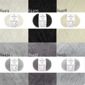 May include: Six skeins of yarn in various colors, including white, black, cream, gray, and light gray. Each skein is labeled "GAZZAL SUPER KID MOHAIR".