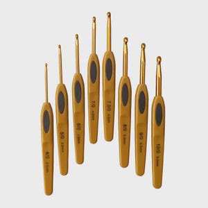May include: A set of eight crochet hooks with gold-colored metal hooks and tan handles with black oval grips. The hooks are labeled with sizes ranging from 4/0 (2.5mm) to 10/0 (6.0mm).