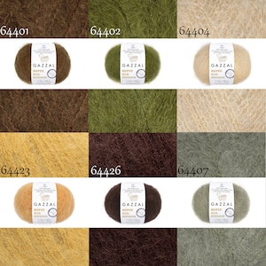 May include: Nine skeins of yarn in various colors, including brown, green, beige, and yellow. Each skein is labeled "GAZZAL SUPER KID MOHAIR".