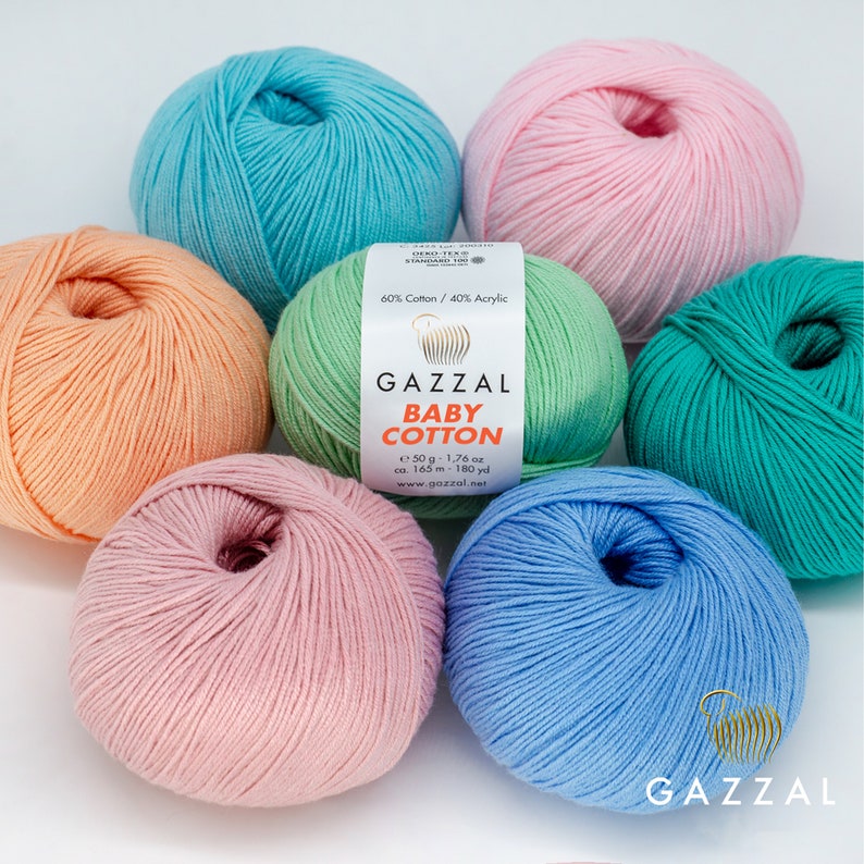 May include: Six balls of yarn in various pastel colors, including light blue, pink, peach, green, and a lighter shade of blue. The yarn is labeled "GAZZAL BABY COTTON" and includes the composition: "60% Cotton / 40% Acrylic".