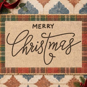 May include: A rectangular doormat with a tan center featuring the black text Merry Christmas in a mix of block and script fonts. The mat has a frayed edge border with a green and red plaid pattern. The design is flat and rectangular in shape.